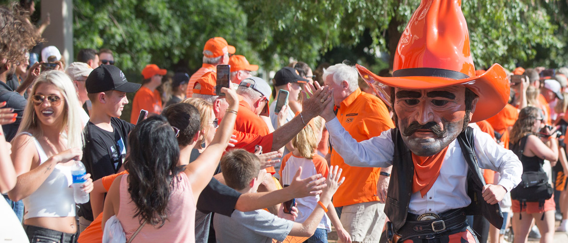 Pistol Pete high fives the crowd as he finishes out another semester strong.