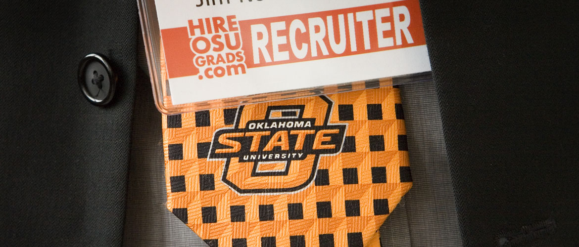 HireOSUGrads recruiter tag hangs right above orange and black OSU tie