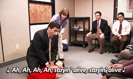 GIF of Michael Scott learning to do CPR and singing "Stayin' Alive"
