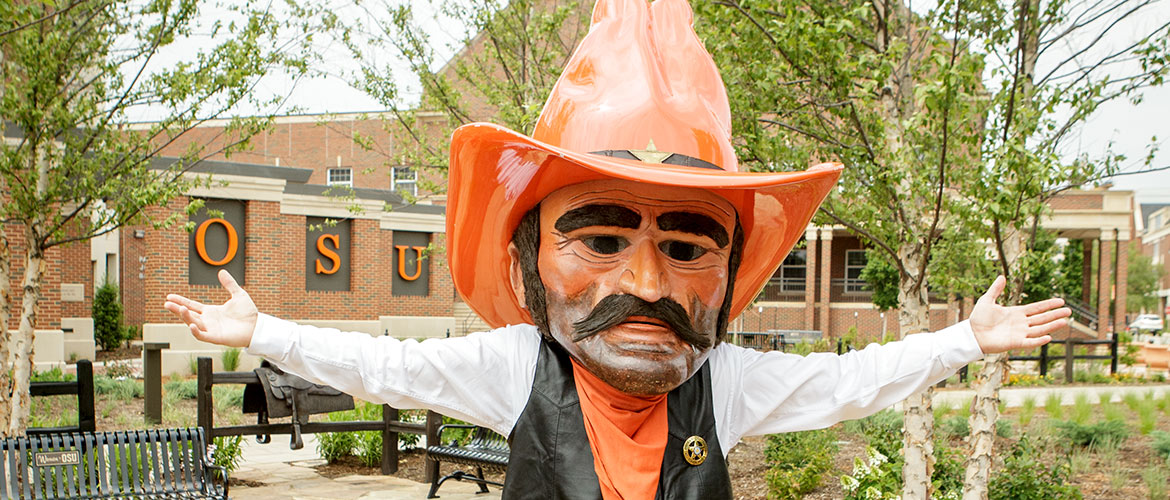 Pistol Pete stands on campus with open arms.