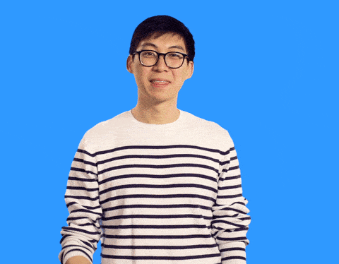 GIF of a person pointing to the camera and making a heart with their hands