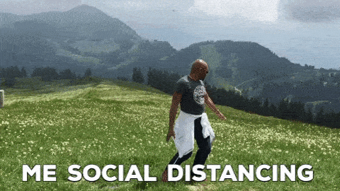GIF of someone spinning around on a hillside with the text, "Me social distancing."