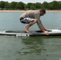 Guy falling on paddle board