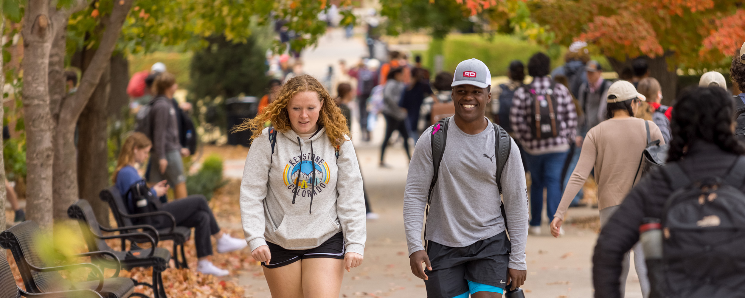 Two students walking on campus